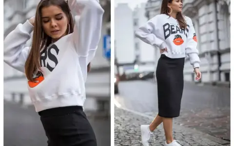 Stylowy crewneck z napisem Chicago Bears i grafiką, zestawiony z czarną spódnicą ołówkową i białymi sneakersami.